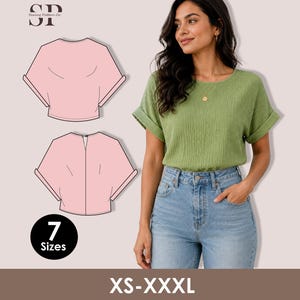 Op de afbeelding: Een saliegroene top met korte mouwen, omgeslagen boorden en een ronde halslijn, gecombineerd met een lichtblauwe spijkerbroek. De afbeelding bevat roze technische lijntekeningen van de voor- en achterkant, de tekst SP Sewing Pattern Co en 7 Sizes XS-XXXL.