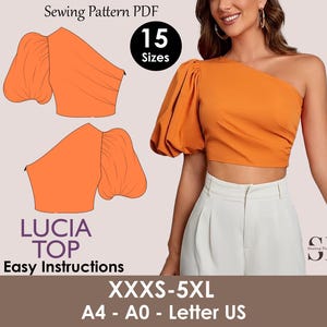 May include: An orange one-shoulder top with a puffed sleeve, shown in a sewing pattern PDF. The pattern includes 15 sizes, from XXXS to 5XL, and easy instructions. The text "LUCIA TOP" is displayed. The pattern is for A4, A0, and Letter US paper sizes.