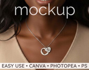 May include: A silver necklace with a heart pendant and a smaller heart charm. The word "mockup" is displayed in white text above the necklace. The text "EASY USE • CANVA • PHOTOSHOP • PS" is displayed below the necklace.