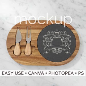May include: Wooden cheese board with a dark gray slate insert featuring a decorative crest design. Includes a cheese knife and fork with wooden handles. The text "EASY USE • CANVA • PHOTPEA • PS" is at the bottom.