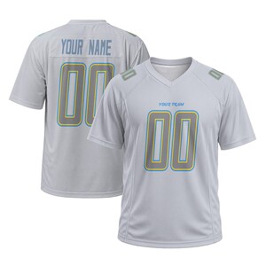 May include: A light gray V-neck jersey featuring the text YOUR TEAM on the front and YOUR NAME on the back. Both sides display the number 00 in gray with yellow and blue outlines. The shoulders also feature small rectangular accents with the number 00.