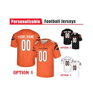 May include: Personalizable football jerseys featuring three color options. Option 1 is orange with black tiger stripes, Option 2 is black with white stripes, and Option 3 is white with black stripes. Each jersey displays the text YOUR NAME and 00.