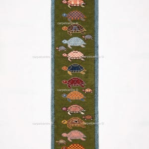 May include: A long, rectangular green rug with a repeating pattern of turtles in various colors. The turtles are arranged vertically, with a mix of large and small sizes. The rug has a blue border and fringed edges.