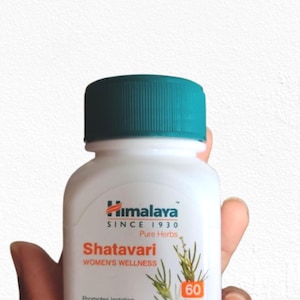 May include: A white bottle of Himalaya Shatavari tablets with a teal cap. The label features the brand name, product name, and the text "WOMEN'S WELLNESS". The bottle contains 60 tablets and promotes lactation.