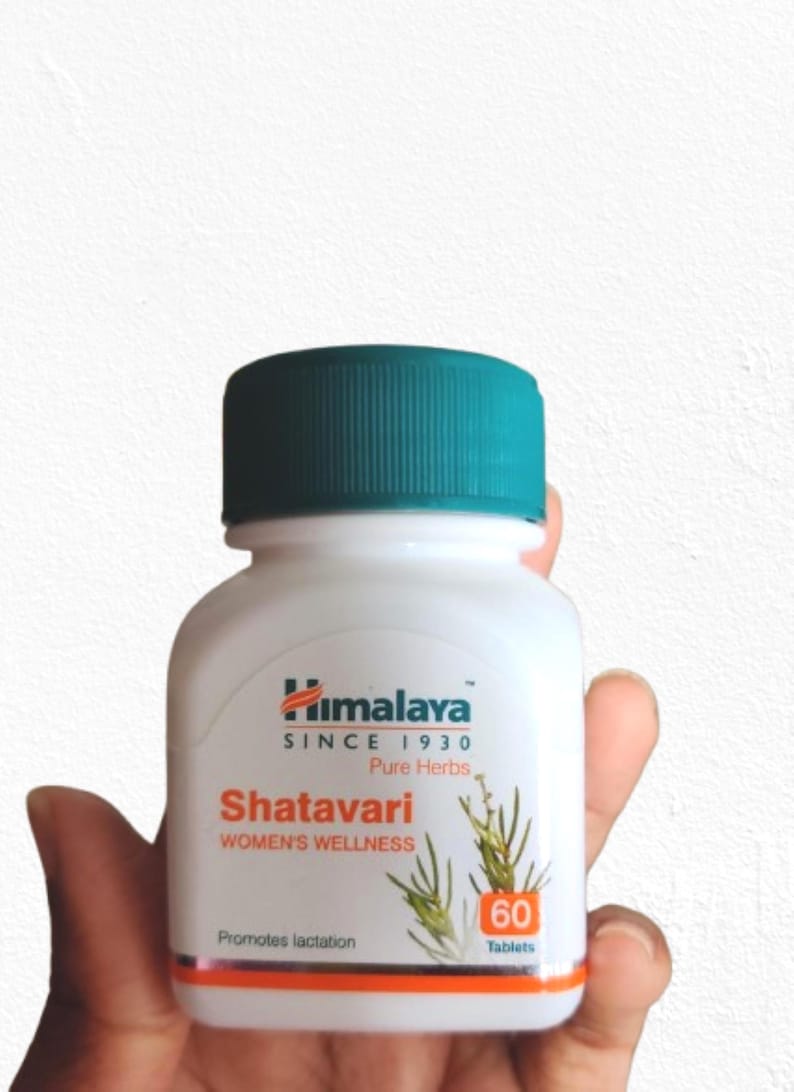 May include: A white bottle of Himalaya Shatavari tablets with a teal cap. The label features the brand name, product name, and the text "WOMEN'S WELLNESS". The bottle contains 60 tablets and promotes lactation.