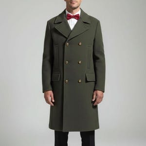 May include: An olive green double-breasted overcoat with gold buttons. The coat features a classic design with a notched collar and front pockets. The person in the image is wearing a red bow tie and a white dress shirt.