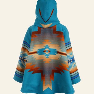 May include: A turquoise hooded poncho with a Southwestern-inspired geometric pattern in shades of orange, brown, and blue. The poncho features a hood and wide sleeves, offering a comfortable and stylish outerwear option.