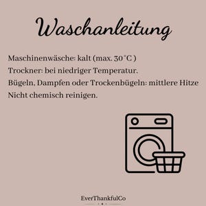 May include: A beige card with the word "Waschanleitung" in elegant script. Below, care instructions are listed: machine wash cold (max. 30&deg;C), tumble dry low, iron on medium heat, and do not dry clean. A washing machine and basket icon are shown.