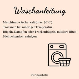 May include: A beige card with black text and a washing machine icon. The text reads "Waschanleitung" and provides washing instructions: cold machine wash (max. 30&deg;C), tumble dry low, iron or steam on medium heat, and do not dry clean. The brand name "EverThankfulCo" is at the bottom.