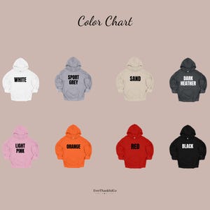 May include: Color chart showing eight hooded sweatshirts in various colors: white, sport grey, sand, dark heather, light pink, orange, red, and black. Each hoodie has the color name printed on it.