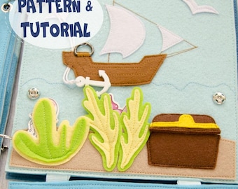 May include: A handmade felt quiet book page with a nautical theme. Features a brown ship, white sails, an anchor, and a treasure chest. The text "PATTERN & TUTORIAL" is displayed on the top left. The background is light blue with felt seaweed.