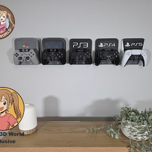May include: A display of five game controller holders for PlayStation consoles, including PS1, PS2, PS3, PS4, and PS5. The controllers are black and white. The holders are mounted on a white wall. The image also includes a wooden table.