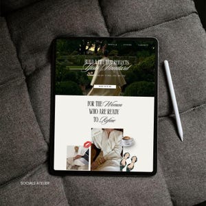 May include: A black tablet displaying a website with the text "Build a life that reflects your standard" and "For the Women Who Are Ready to Refine." A white stylus rests beside the tablet on a gray, textured surface. The website features images of a woman and a cup of coffee.