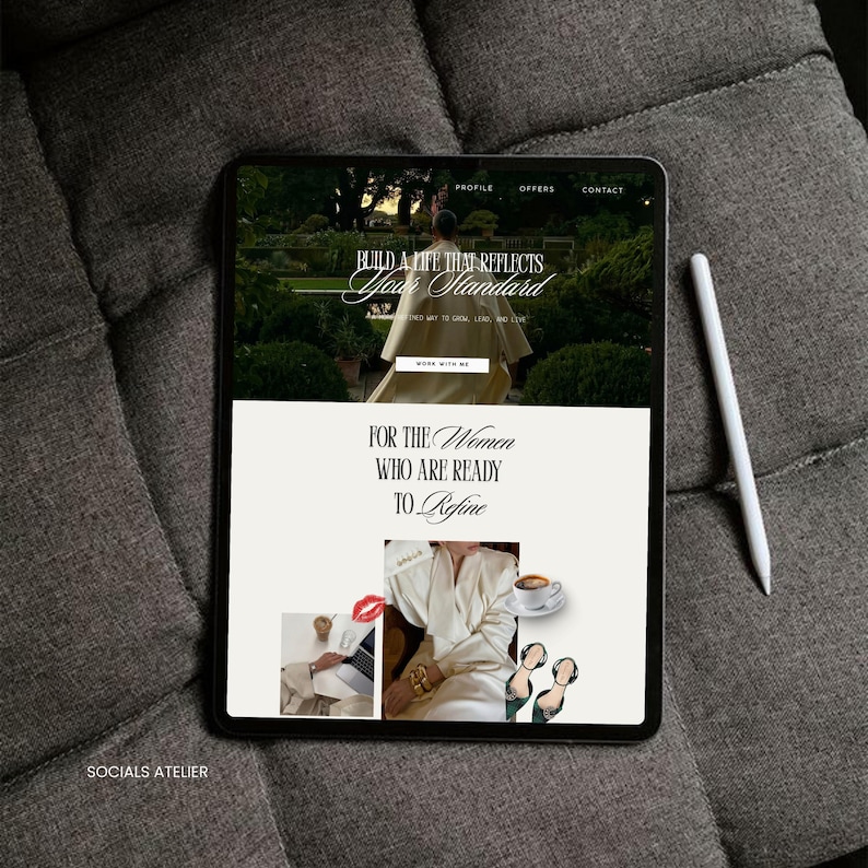 May include: A black tablet displaying a website with the text "Build a life that reflects your standard" and "For the Women Who Are Ready to Refine." A white stylus rests beside the tablet on a gray, textured surface. The website features images of a woman and a cup of coffee.