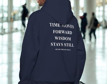 May include: A navy blue hoodie with the text "TIME MOVES FORWARD WISDOM STAYS STILL" in white. The hoodie is worn by a person in a well-lit airport setting.