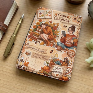 May include: A cozy scene with a lit candle, a small clock, and a decorative book cover with the text "Cozy Chapters" and illustrations of people reading. A succulent plant, a pen, and a small figurine are also present.