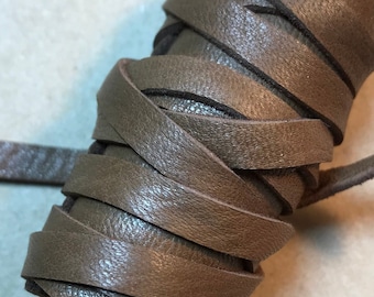 May include: A roll of brown leather cord, perfect for crafting projects.