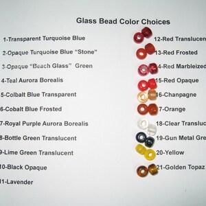 May include: A color chart of glass beads with the text "Glass Bead Color Choices." The beads are arranged in rows, showcasing various colors like turquoise, green, purple, red, and yellow. Each bead is labeled with a number and color name.
