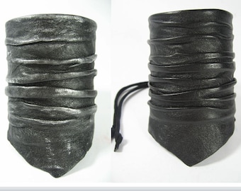 May include: Two leather bracelets with a layered, pleated design. One bracelet is black and the other is silver.
