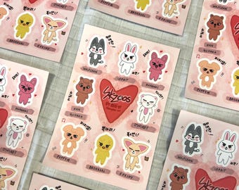 May include: Sheets of stickers featuring cartoon animal characters in various colors. Each sticker sheet has a large red heart with the text "Skzoo" and character names. The stickers are on a light pink background.
