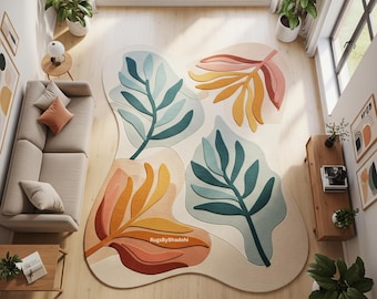 Puede incluir: Vista aérea de una alfombra abstracta grande con fondo crema. La alfombra presenta formas de hojas coloridas en tonos naranja, rosa, amarillo y verde azulado. La alfombra está en una habitación con piso de madera y un sofá beige. Mide aproximadamente 200 cm x 300 cm.