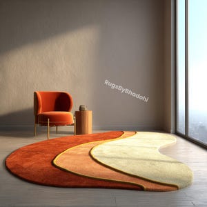 May include: A contemporary, abstract rug in orange, peach, and cream, with a curved, layered design. The rug is on a wooden floor, with an orange armchair and a small wooden side table. The rug's dimensions are approximately 244 x 152 cm.