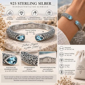 Puede incluir: Un brazalete de plata de ley 925 con intrincados patrones de volutas y dos piedras preciosas azules en forma de pera en los extremos abiertos. La pulsera tiene un cierre de bisagra, una circunferencia interior de 16,5 cm y pesa 35 gramos.