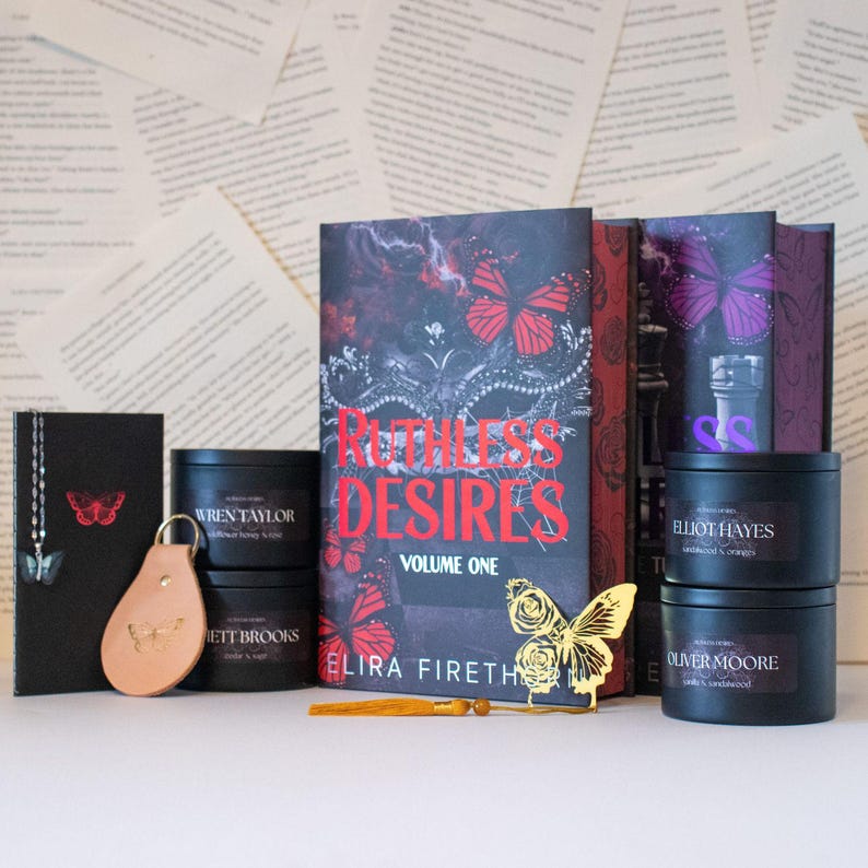 May include: A collection of items with a butterfly theme, including a book titled "Ruthless Desires," candles, a leather keychain, and a bookmark. The book cover is black with red butterflies. The candles are in black containers.