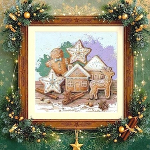 May include: A framed cross-stitch depicting festive gingerbread cookies: a gingerbread man, stars, a house, and a reindeer. The frame is adorned with greenery, gold baubles, and a hanging gold star. The background has a green and gold pattern.