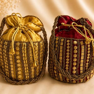 May include: Two drawstring pouches, one in gold and one in deep red, featuring intricate vertical rows of metallic beads, square sequins, and floral-shaped embellishments. Each bag has a braided beaded handle and a matching drawstring closure.