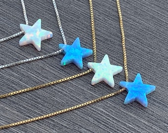 May include: Four silver and gold chains with opal star pendants. The stars are in shades of blue and white.