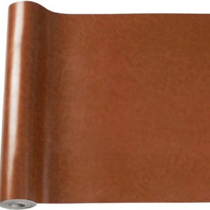 May include: A roll of brown faux leather material. The material is a solid, warm brown colour with a slight sheen, suggesting a smooth surface. The roll is partially unrolled, revealing the underside of the material.