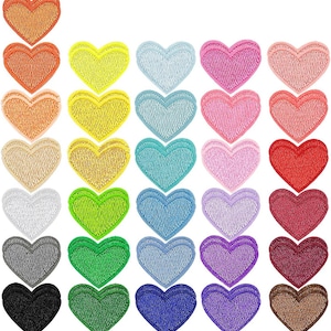 May include: A selection of heart-shaped patches in a variety of colours, such as orange, yellow, blue, pink, red, green, purple, and brown. The patches have a textured finish and are arranged in rows and columns.
