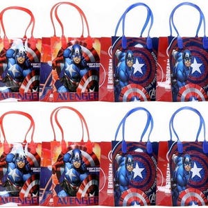 May include: A collection of Captain America-themed gift bags. Each bag features a vibrant image of Captain America, a white star, and a shield design. The bags have red or blue handles and are ideal for party favors.
