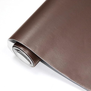 May include: A roll of brown faux leather material with a textured surface. The material is rolled up, revealing a white backing. The color is a rich, warm brown, suitable for various craft and design projects.