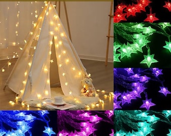 May include: A white teepee tent adorned with star-shaped fairy lights. The image displays various colours of star lights, including red, green, purple, blue, pink, and teal. The text "16 Solid-colors" is at the top.
