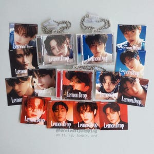 May include: A collection of "Lemon Drop" themed merchandise, including CD cases and photo cards. The items feature images of young men and the text "Lemon Drop". Some items are attached to clear plastic keychains.