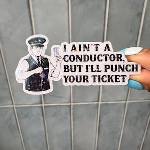 May include: A die-cut sticker featuring a conductor in a dark vest and cap holding a ticket. The sticker has a holographic star pattern and black text that reads: I AIN'T A CONDUCTOR, BUT I'LL PUNCH YOUR TICKET. The design has a white border.