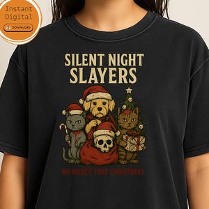 Könnte beinhalten: Schwarzes T-Shirt mit dem Text "SILENT NIGHT SLAYERS" über einer Grafik eines Hundes, zweier Katzen und eines Schädels mit Weihnachtsmützen. Der Satz "NO MERCY THIS CHRISTMAS" steht darunter.