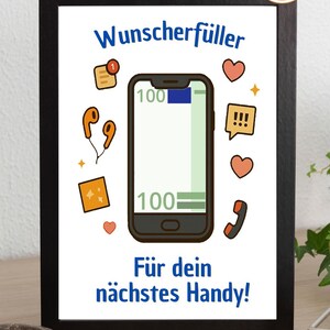 May include: A framed print with a black border features a cartoon illustration of a smartphone with a 100% charge, surrounded by icons like hearts, speech bubbles, and earphones. The text reads "Wunscherfüller" and "Für dein nächstes Handy!"
