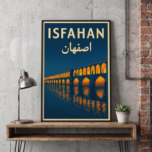 May include: A framed vertical poster featuring a dark blue night sky over a bridge with illuminated orange arches reflecting in the water. The text ISFAHAN is printed in large cream letters at the top, followed by the word in Persian script.