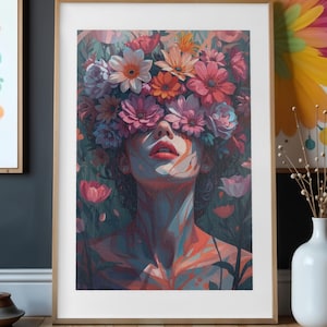 May include: Framed art print featuring a woman's face obscured by a vibrant floral crown. The artwork uses a palette of pinks, oranges, and blues, creating a dreamlike aesthetic. The woman's red lips are a focal point.