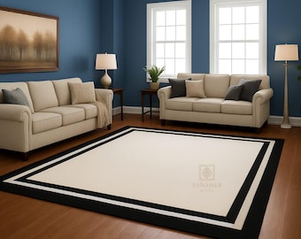 Può includere: Soggiorno con due divani beige, un grande tappeto color crema con bordi bianchi e neri e un dipinto di paesaggio. La stanza ha pareti blu, due finestre e una lampada da terra. Il tappeto misura circa 2,4 x 3,0 metri.