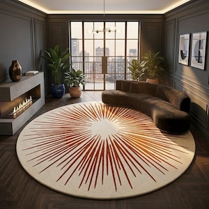 May include: A large circular area rug featuring a cream-colored base with a prominent rust-orange sunburst pattern radiating from the center. The rug is positioned on a dark wood floor in a room with a curved sofa, a fireplace, and potted plants.