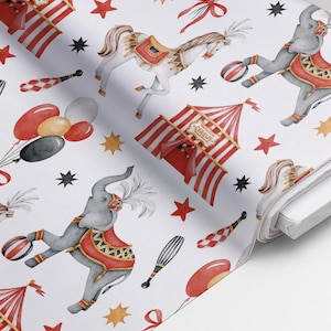 May include: A white fabric featuring a repeating circus pattern with grey elephants wearing red and gold decorative blankets, white horses with red saddles, red and white striped circus tents, red balloons, and black and red juggling pins.