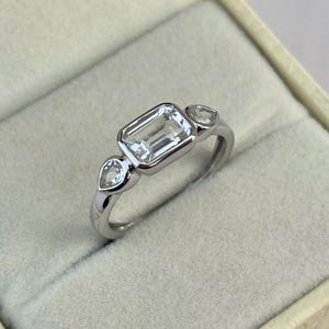 Emerald Cut Moissanite Three Stone Ring, Bezel Set Sterling Silver Band