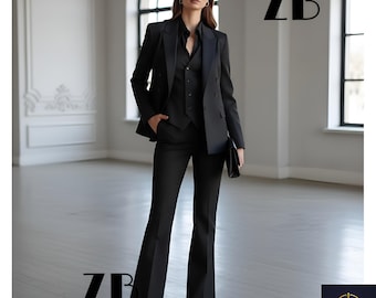 May include: A black three-piece suit with a double-breasted blazer, vest, and flared trousers. The suit is worn with a black collared shirt and a small black clutch. The letters "ZB" are visible in the image. The Zevan Bespoke logo is in the bottom right corner.
