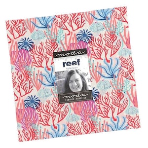 May include: A square fabric piece with a colorful coral reef pattern. The design features red, pink, and blue coral and sea life on a cream background. The fabric is labeled "Reef" by Kate Spain for Moda Fabrics + Supplies.