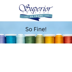 May include: A row of ten spools of thread in various colors, including blue, green, yellow, and orange. The spools are arranged in a rainbow pattern. The text "So Fine!" is written in white letters on a light blue background above the spools. The text "Superior Threads 1998 * 25 Years * 2023" is written in blue letters on a white background above the text "So Fine!"