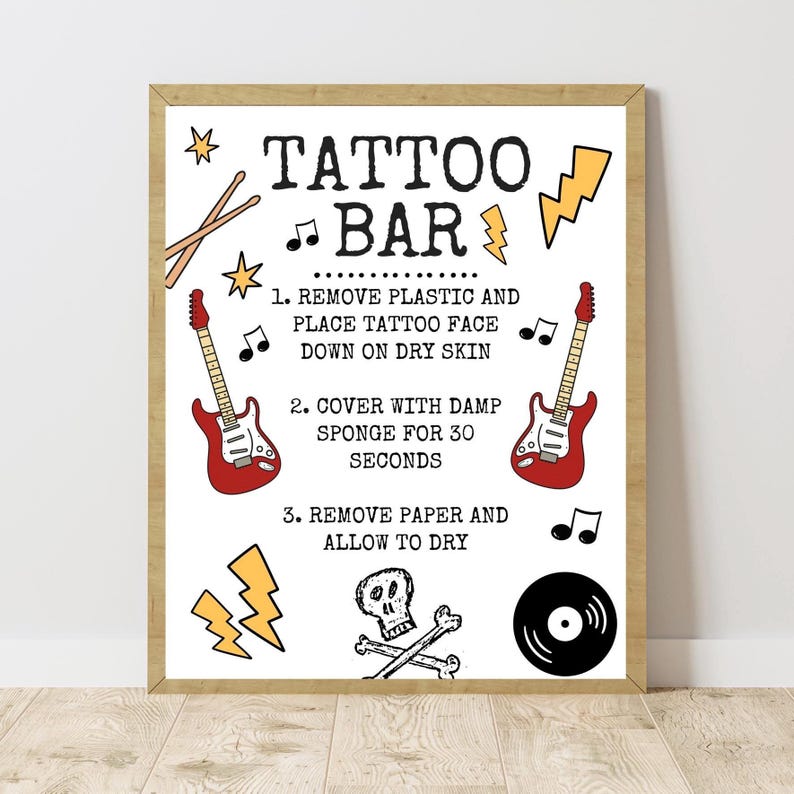 May include: A rectangular sign with a wooden frame featuring the text TATTOO BAR and instructions for application. The design includes illustrations of two red electric guitars, a black vinyl record, a skull with crossbones, lightning bolts, and musical notes.